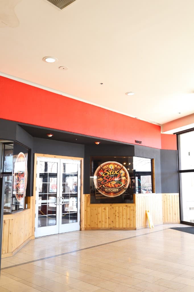 Stix & Soul Kitchen exterior — welcoming storefront with red branding and wooden paneling